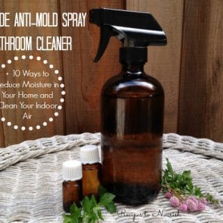 Glass spray bottle with natural cleaner, essential oils and herbs.
