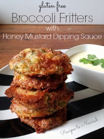 Stacked broccoli fritters with a side of dipping sauce.