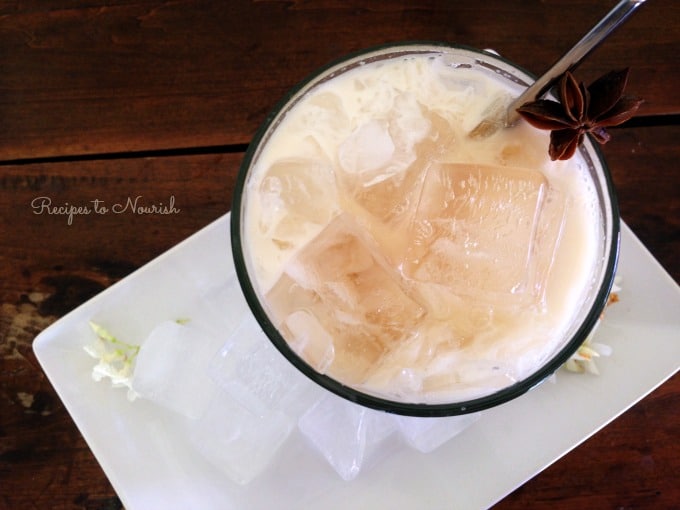 Thai iced tea served over ice with star anise.