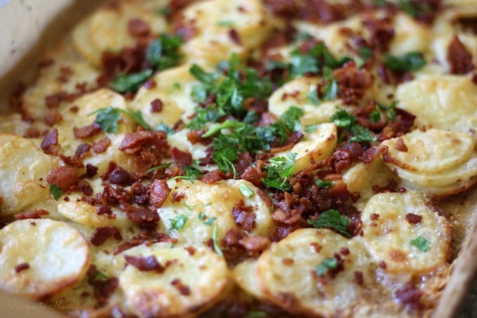 Scalloped potatoes baked with cheese, crispy bacon and topped with fresh herbs.