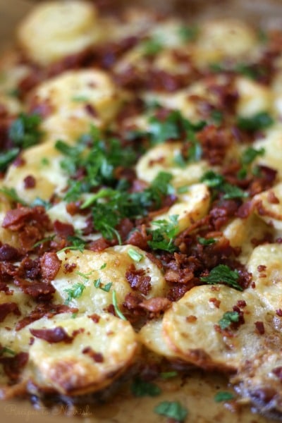 Scalloped potatoes baked with cheese, crispy bacon and topped with fresh herbs.