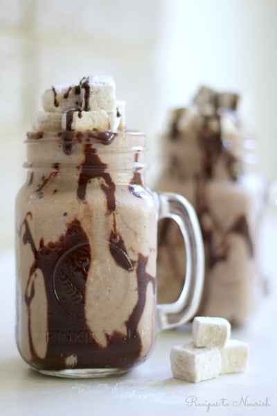 Frozen Hot Chocolate is a super fun treat on a hot summer day. Icy cold, chocolaty, creamy goodness mixed with healthy, whole food ingredients, topped with rich chocolate fudge sauce and homemade marshmallows is sure to please. | Recipes to Nourish