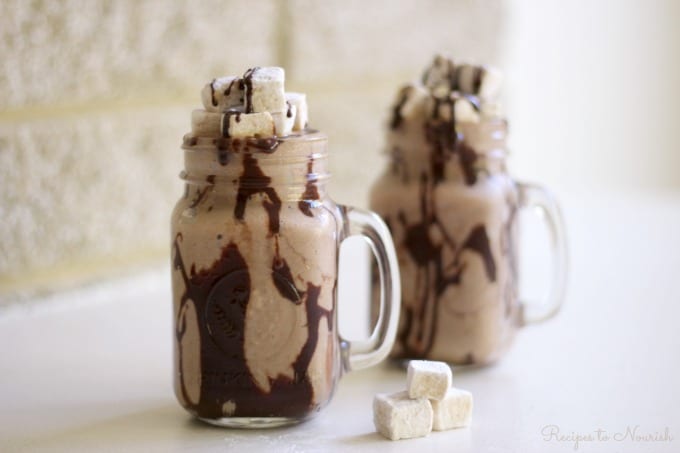Frozen Hot Chocolate is a super fun treat on a hot summer day. Icy cold, chocolaty, creamy goodness mixed with healthy, whole food ingredients, topped with rich chocolate fudge sauce and homemade marshmallows is sure to please. | Recipes to Nourish