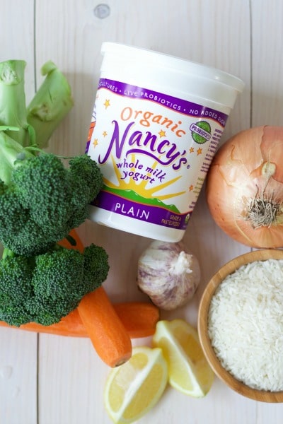 Nancy's brand organic whole milk yogurt and fresh broccoli, carrots, garlic, lemon, onion and white rice.