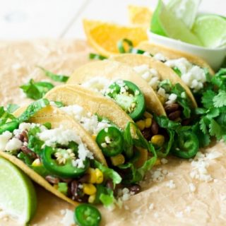 (Ad) These healthy and hearty vegetarian black bean tacos are stellar! They’re deeply flavored with hints of sweet orange and chocolate, spicy cumin and jalapeños, and packed with creamy black beans, sweet corn and salty olives. | Recipes to Nourish