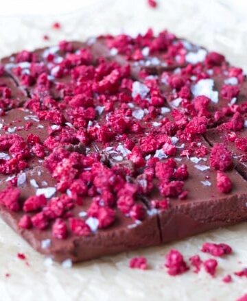 Chocolate Freezer Fudge is so easy to make! This creamy, delicious, chocolatey perfection is topped with sweet, crunchy freeze-dried raspberries and flaked sea salt. It has a special nourishing protein boost too! | Recipes to Nourish