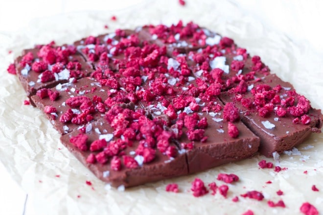 Chocolate Freezer Fudge is so easy to make! This creamy, delicious, chocolatey perfection is topped with sweet, crunchy freeze-dried raspberries and flaked sea salt. It has a special nourishing protein boost too! | Recipes to Nourish