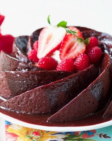Chocolate cake with chocolate glaze topped with berries.