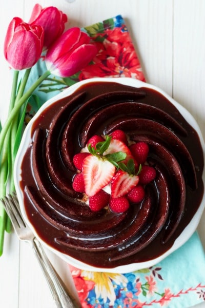 Chocolate cake with chocolate glaze topped with fresh berries.