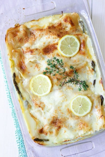 Creamy white sauce lasagna with cheesy topping, fresh lemon slices and fresh thyme.