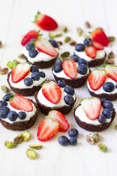 (Ad) Grain Free Mini Berry Yogurt Breakfast Tarts are a fun little bite for special occasions and brunches. These healthy tarts are topped with fresh seasonal berries, nestled in a homemade pistachio crust. | Recipes to Nourish