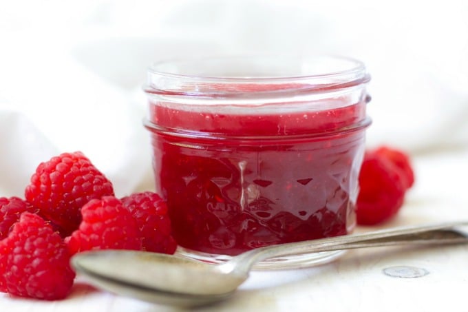 Fresh raspberries and a jar or homemade raspberry sauce.