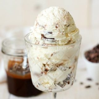 Protein packed, dreamy cheesecake ice cream, brimming with decadent, fudgy, grain free brownies and swirled with homemade chocolate fudge sauce. This Paleo Brownie Cheesecake Ice Cream is practically perfect in every way. | Recipes to Nourish