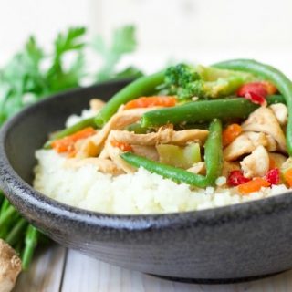 (ad) Thinly sliced chicken stir-fried with frozen vegetables and topped on riced cauliflower is so easy to make! This budget-friendly, Frozen Vegetable Asian Chicken Stir Fry Cauliflower Bowl is packed with a sweet gingery flavor and whips up in 15 minutes, making it a perfect weeknight meal. | Recipes to Nourish
