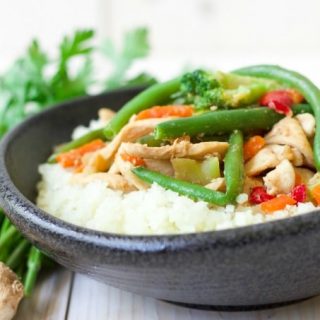 (ad) Thinly sliced chicken stir-fried with frozen vegetables and topped on riced cauliflower is so easy to make! This budget-friendly, Frozen Vegetable Asian Chicken Stir Fry Cauliflower Bowl is packed with a sweet gingery flavor and whips up in 15 minutes, making it a perfect weeknight meal. | Recipes to Nourish