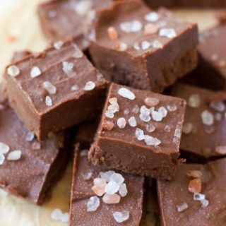 Chocolate fudge cut into squares with pink salt on the top.