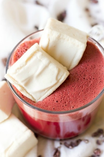 Mug of red beet hot chocolate with homemade marshmallows.