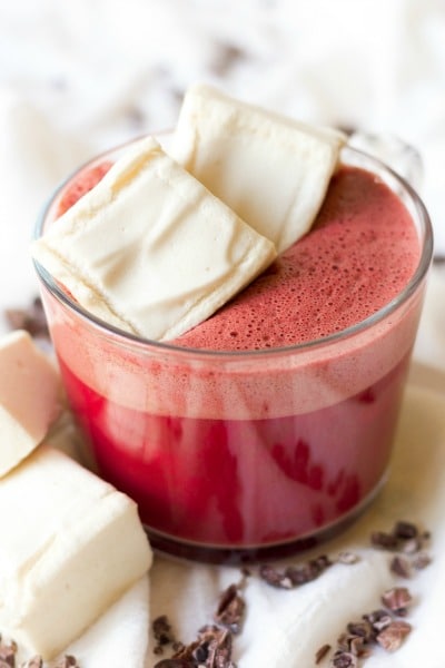 Mug of red beet hot chocolate topped with homemade marshmallows.