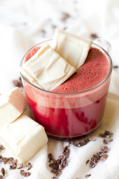 Mug of red beet hot chocolate with homemade marshmallows.