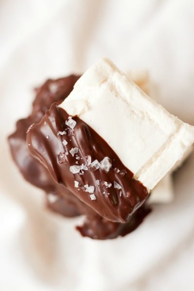 Homemade marshmallows dipped in chocolate and topped with flaked sea salt.
