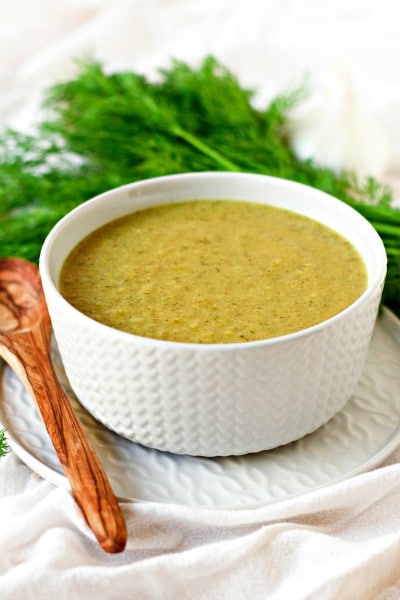 Broccoli soup in a bowl with fresh dill.