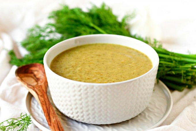 Broccoli soup in a bowl with fresh dill.