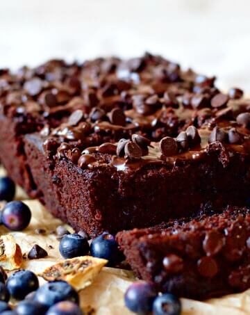 Chocolate banana bread with blueberries, chocolate chips and pieces of dried oranges.