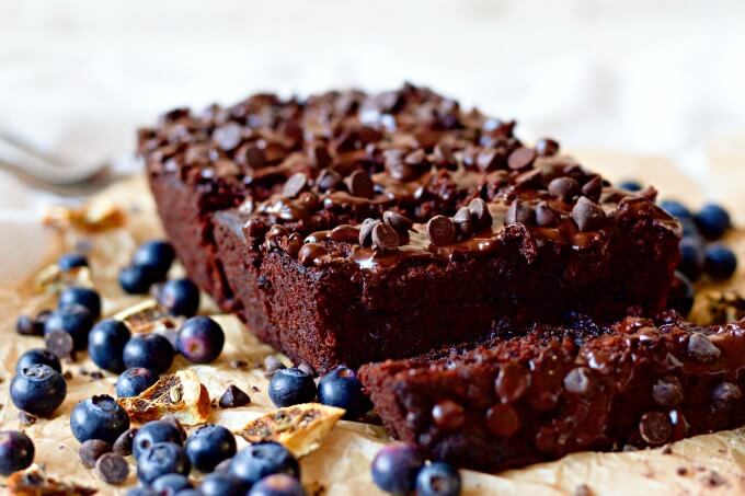 Chocolate banana bread with blueberries, chocolate chips and pieces of dried oranges.