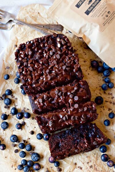 Chocolate banana bread with blueberries and a bag of tea. 