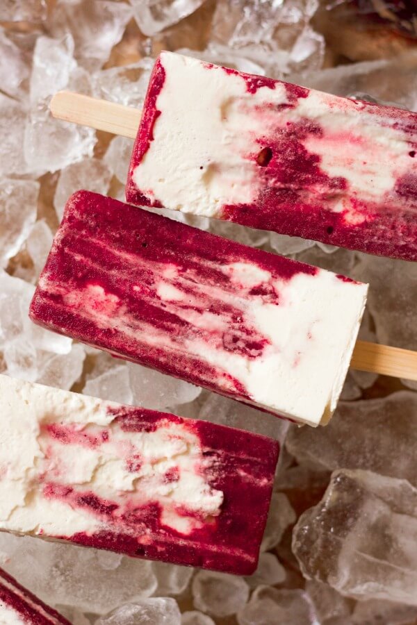 Marbled cherry and vanilla creamsicles on ice.