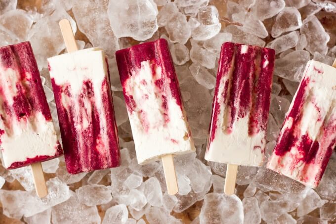 Marbled cherry and vanilla creamsicles on ice.