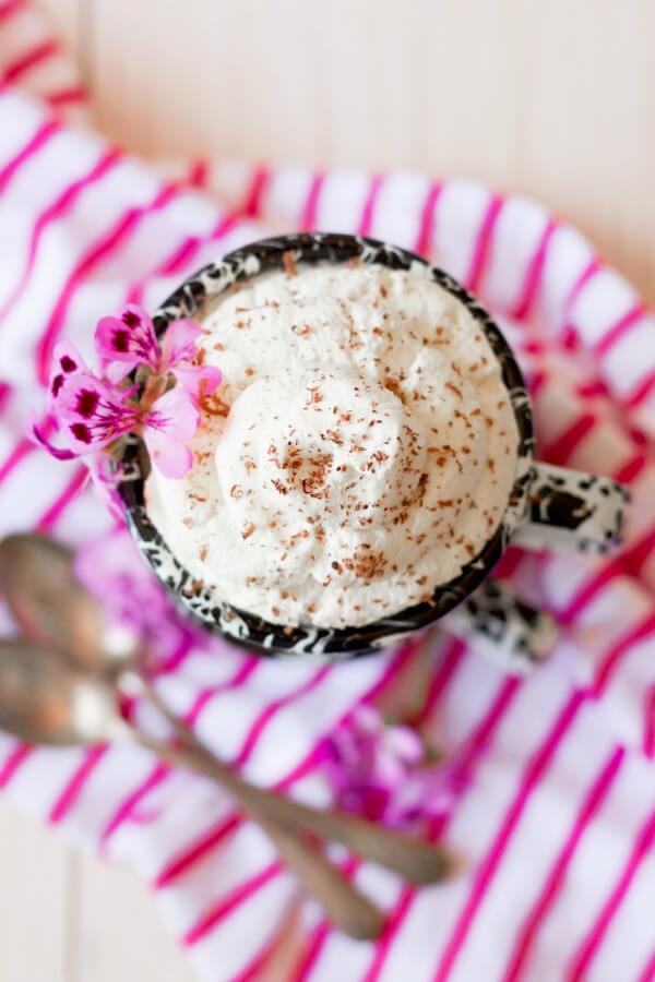 Mug full of homemade whipped cream topped with shaved chocolate.