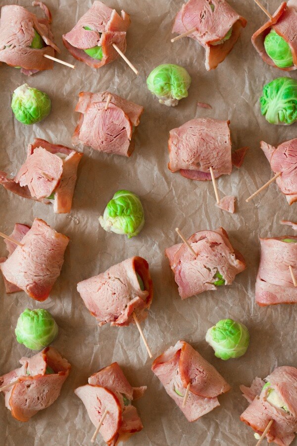 Bacon wrapped Brussels sprouts on a baking sheet.