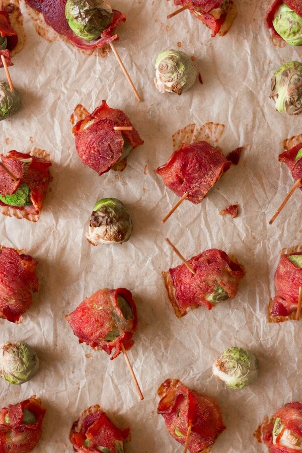 Bacon wrapped Brussels sprouts on a baking sheet.