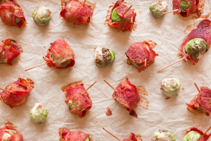 Bacon wrapped Brussels sprouts on a baking sheet.