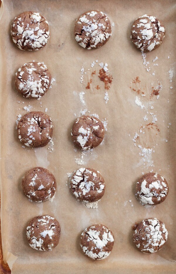 Chocolate crinkle cookies on a baking sheet.