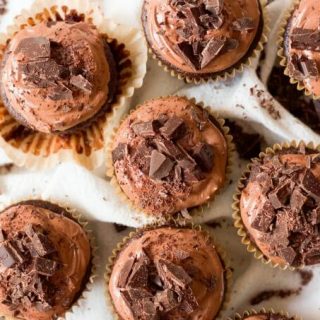 Chocolate cupcakes with chocolate frosting and chocolate chunks on the top.