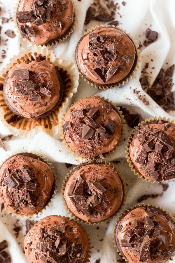 Chocolate cupcakes with chocolate frosting and chocolate on the top.