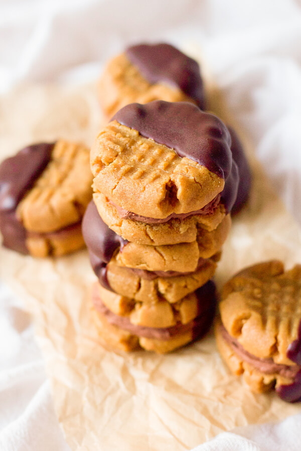 Peanut butter sandwich cookies filled with chocolate cream and half dipped in chocolate.