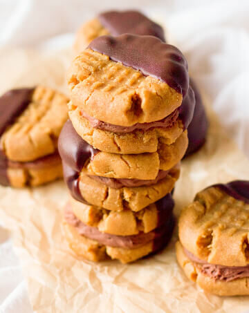 Peanut butter sandwich cookies filled with chocolate cream and half dipped in chocolate.