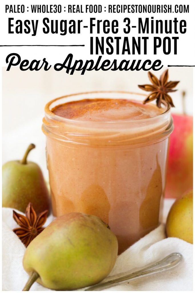 Jar of homemade pear applesauce next to fresh pears, apples and star anise pods.