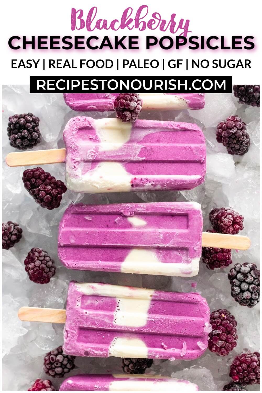 Creamy and purple swirled homemade popsicles sitting on ice next to blackberries.