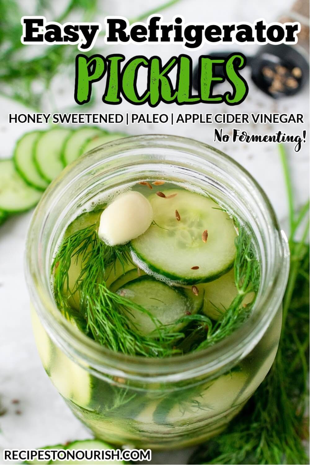 Mason jar filled with sliced pickles, fresh dill, garlic clove and liquid brine, surrounded by sliced cucumbers, fresh dill, spices and the text Easy Refrigerator Pickles.