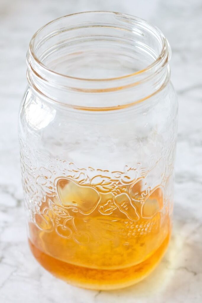 Mason jar filled ¼ full with apple cider vinegar.