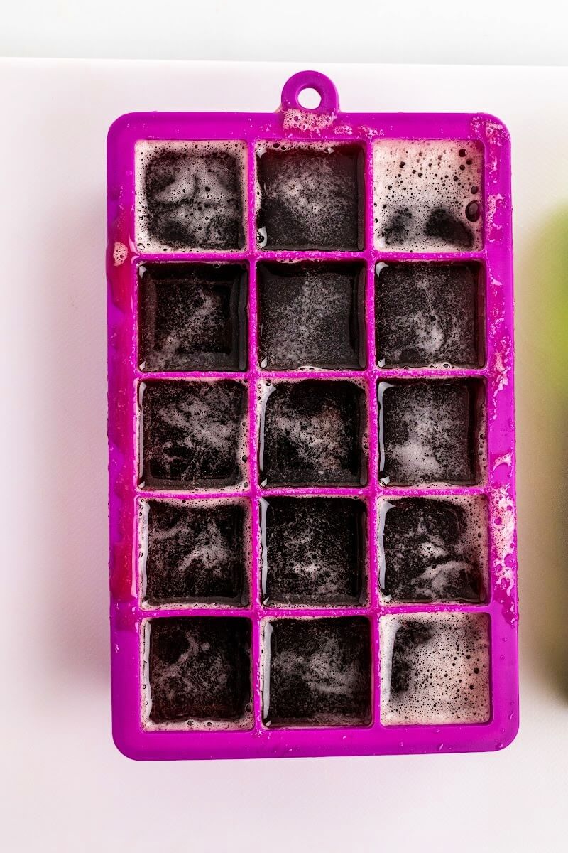 Purple silicone mold filled wit dark purple homemade gelatin gummies.