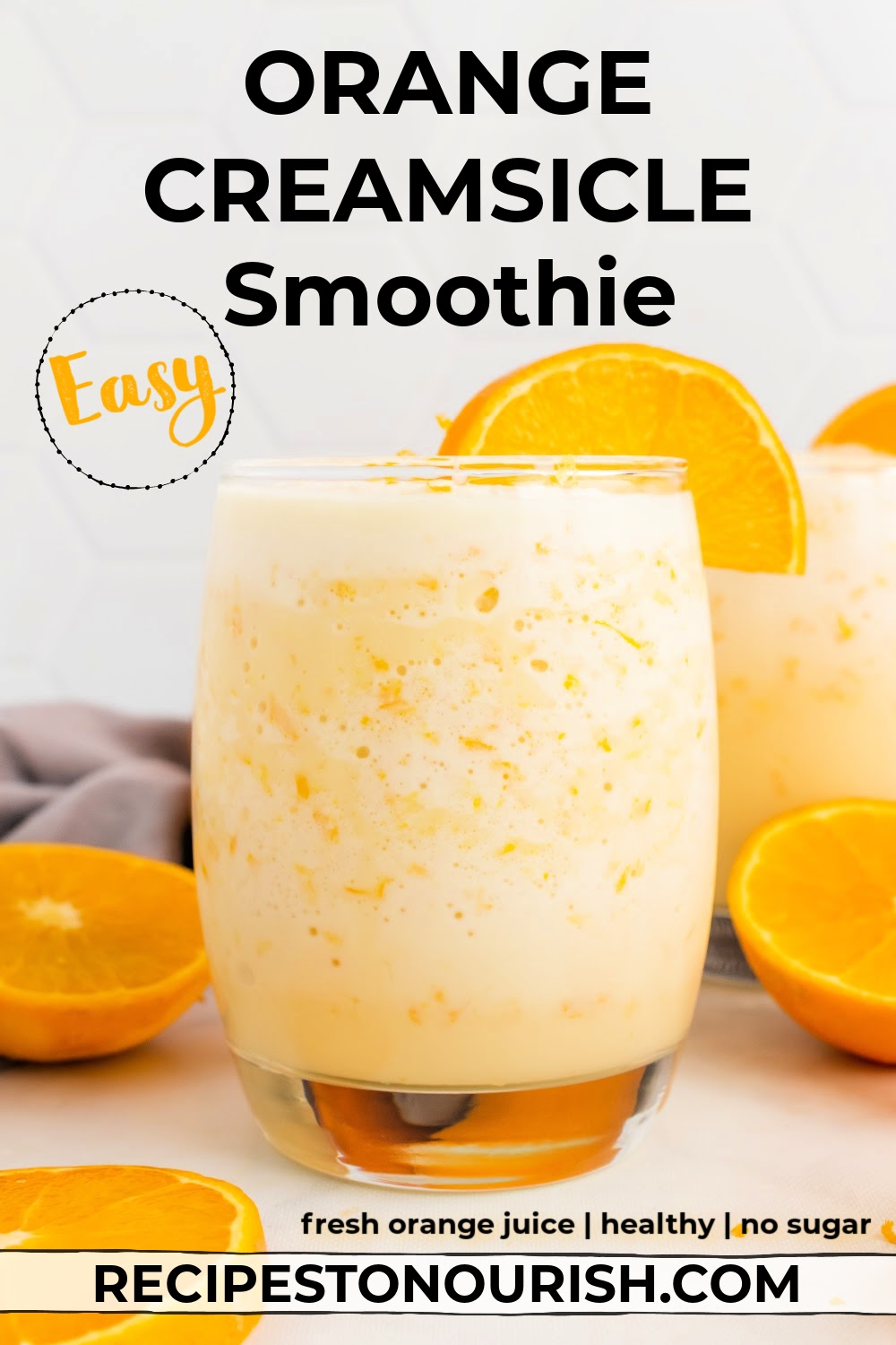 Creamy orange smoothie in a two glasses with fresh orange slices and whole oranges slices in the background and text that says Orange Creamsicle Smoothie, easy, fresh orange juice, healthy, no sugar.